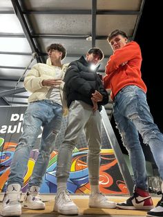 three young men standing next to each other