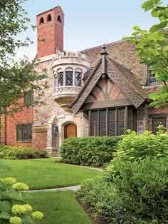 a large brick house with a tall tower