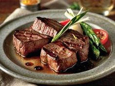 steak with sauce and asparagus on a plate