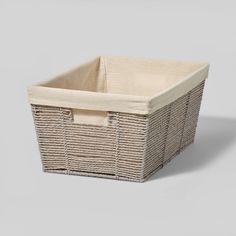 an empty wicker basket on a grey background