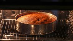 a cake pan in an oven with the door open