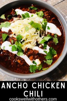 a bowl of chili with cheese and cilantro