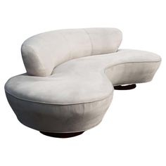 a white couch and ottoman sitting next to each other