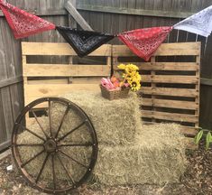 an old wagon with hay and flowers on it