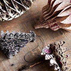 some paper flowers sitting on top of a wooden table