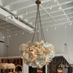 a large chandelier hanging from the ceiling in a room with many lights on it