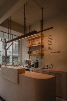 a kitchen with lots of counter space next to a large glass window that looks out onto the street