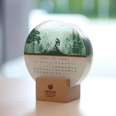 a desk top with a calendar on it and a wooden stand in front of it