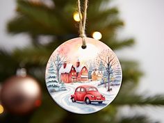 a christmas ornament with a red car driving down the road in front of a house