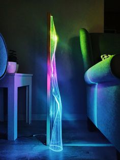 an illuminated floor lamp in the corner of a room