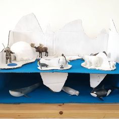 an iceberg with penguins, polar bears and other animals on it's shelf