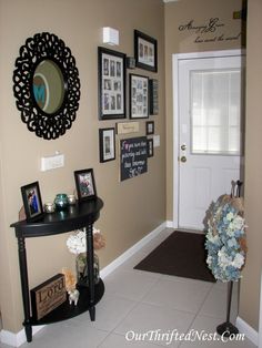 a hallway decorated with pictures and flowers on the wall