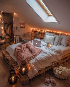 an attic bedroom with a bed made out of pallets and lights on the ceiling