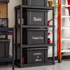 three bins are stacked on top of each other in a room with ladders