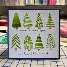 a handmade christmas card with watercolor trees