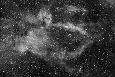 black and white image of stars in the night sky, with an open star cluster