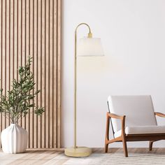 a living room with a chair, lamp and plant