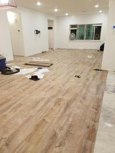 an empty room with hard wood flooring being installed