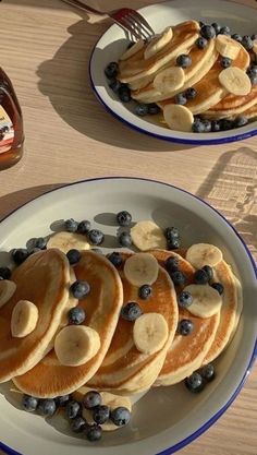 pancakes with bananas and blueberries on a plate