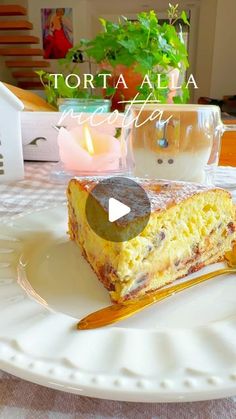 a piece of cake sitting on top of a white plate next to a glass filled with liquid