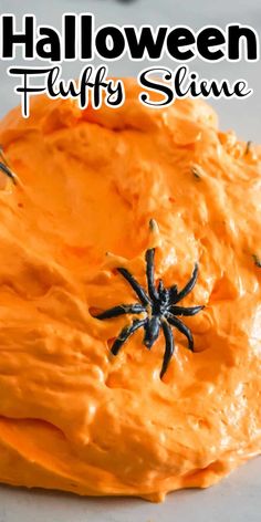 an orange slime with black spider decorations on it and text overlay that reads halloween fluffy slime