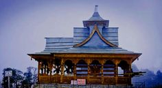 an old wooden building with a steeple on top