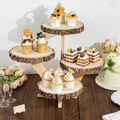 three tiered cake stand with cupcakes on it