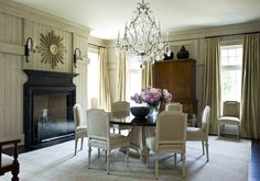 a dining room table with chairs and a chandelier