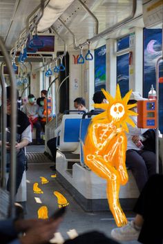 an image of a cartoon character on a subway car with people sitting and standing around