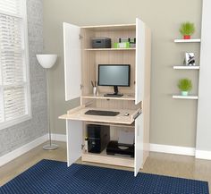 a computer desk with a monitor, keyboard and mouse