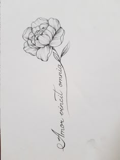 a black and white drawing of a flower with the word love written in cursive writing