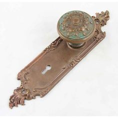 an antique door handle with a decorative design on it