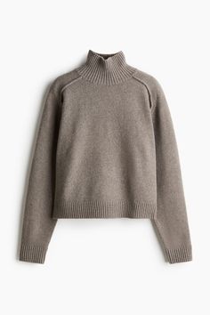 Short  loose-fit sweater in a soft knit. Mock turtleneck  long saddle sleeves with visible seams  and ribbing at neck  cuffs  and hem.