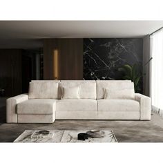 a white couch sitting in front of a window