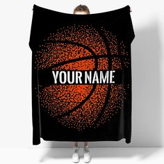 a woman holding up a basketball towel with the words your name on it