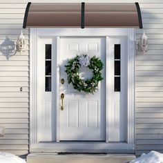 a white front door with a wreath on it