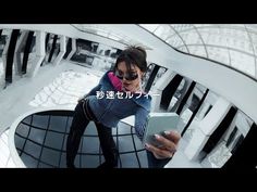 a woman sitting on top of a metal structure holding a cell phone in her hand