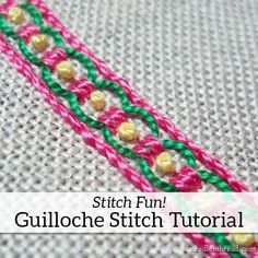 a close up of a pink, green and yellow beaded edge on a piece of fabric