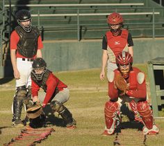 some baseball players are on the field with catchers mitts and gloves in their hands