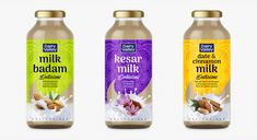 three bottles of kesar and cinnamon milk on a white background, each containing different flavors