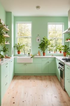 a kitchen filled with lots of green plants next to a sink and stove top oven