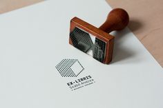 a rubber stamp with the word ex libris on it and a wooden handle