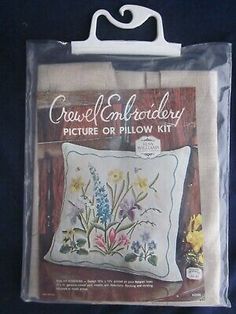 the cross stitch pillow kit is packaged in plastic bag and it has flowers on it