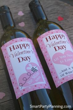 two wine bottles with valentine's day tags on them sitting next to each other