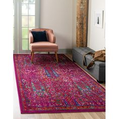 a living room area with a pink rug, chair and large mirror on the wall