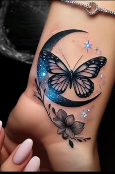 a woman's arm with a butterfly and flower tattoo on the left side of her body