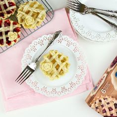 two plates with waffles on them next to a bag of chips and a fork