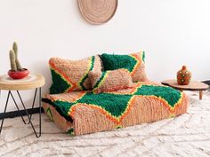 a living room with a couch, table and potted plant