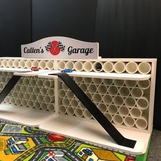 a couple of shelves that are next to each other on a carpeted floor in front of a black wall