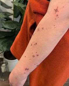 a woman's arm with stars on it